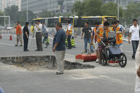Sink holes in Beijing streets after rainstorm