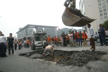 Sink holes in Beijing streets after rainstorm