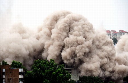 Idle high-rise blasted into rubble