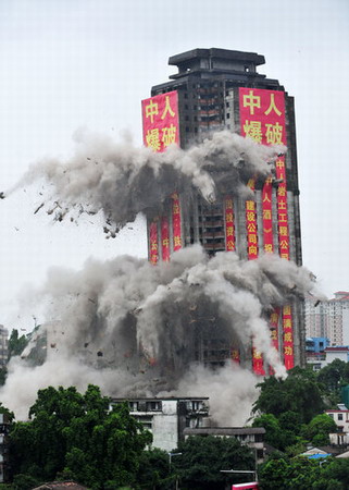 Idle high-rise blasted into rubble