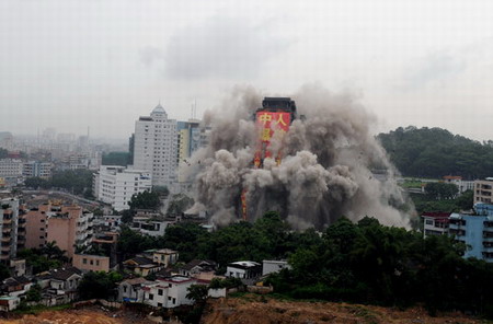 Idle high-rise blasted into rubble