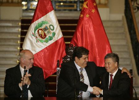 Peru's President Garcia and China's Ambassador in Peru Wuyi shake hands in Lima