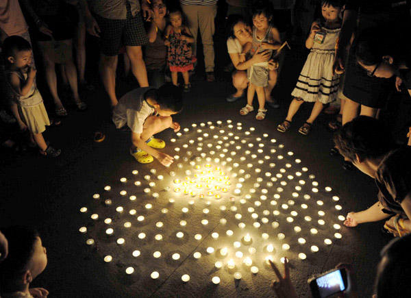 Vigil for child injured in 10-story drop