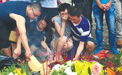 Grief shrouds train crash site