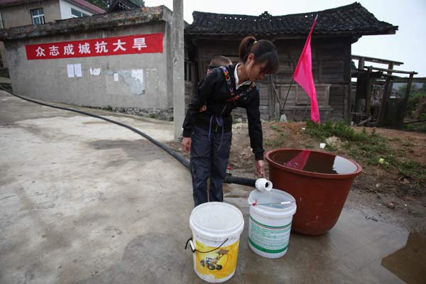 Hose begins taking water to dry village