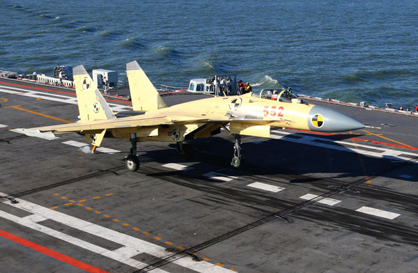 China conducts flight landing on aircraft carrier