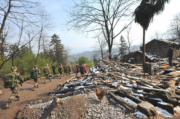 Rescuers leave the scene of in a deadly mudslide in Zhenxiong county of Zhaotong city, Southwest China's Yunnan province, on Jan 12, 2013, after the last body was found in debris. 46 bodies found in Yunnan mudslide retrieved