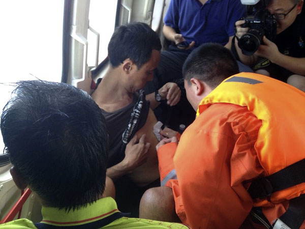 Fishermen receive medical treatment during the transfer to the Yongxing Island by helicopter after they were saved from the sinking ship 'Yuetaiyu 62116', South China's Hainan province, Oct 1, 2013. 14 fishermen rescued, 4 dead, 58 missing after Typhoon Wutip