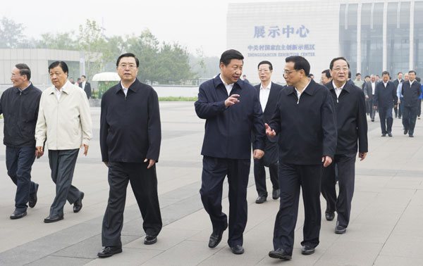 China's top leaders Xi Jinping (2nd R, front), Li Keqiang (1st R, front), Zhang Dejiang (3rd R, front) and other members of the Political Bureau of the Communist Party of China (CPC) Central Committee talk with each other after they visited the Zhongguancun Science Park in Beijing, Sept 30, 2013. China's top 10 domestic events of 2013