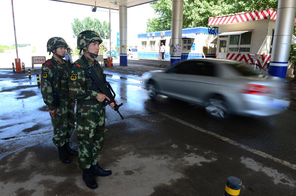 Armed police guard Beijing's border checkpoints