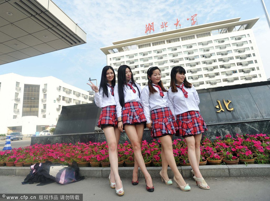 Girls in fashionable school uniforms pose for their graduation photos at Hu...