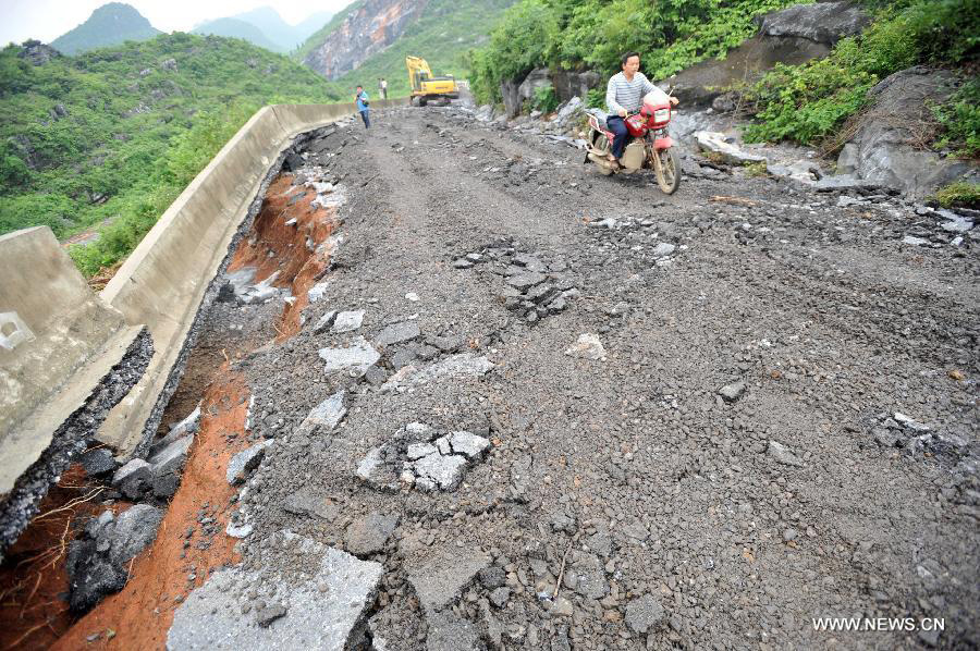 Road destroyed by rain-triggered floods in S China