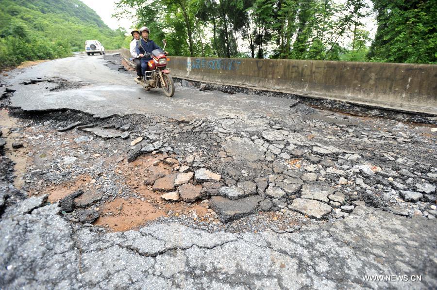 Road destroyed by rain-triggered floods in S China