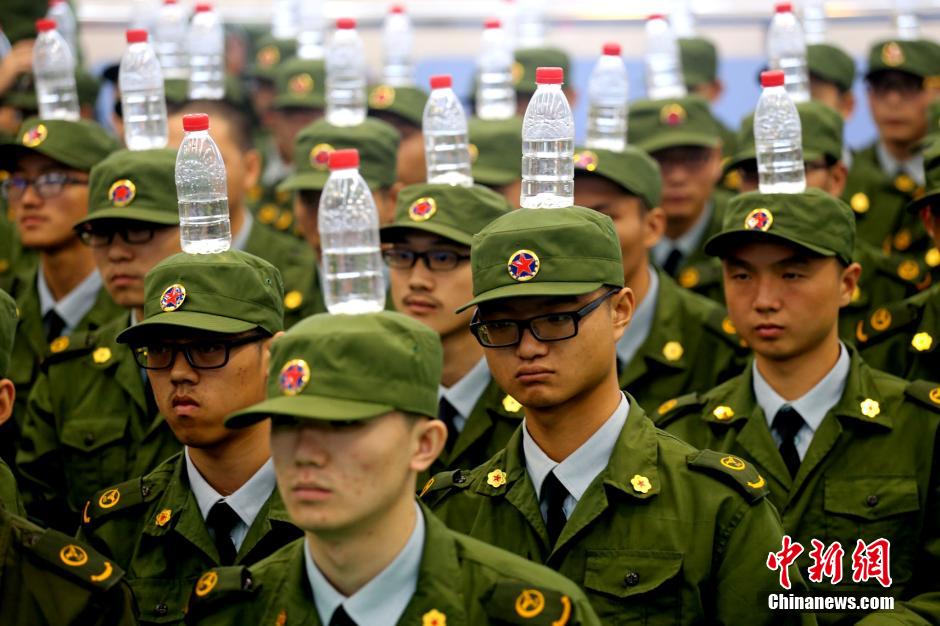 Military training with bottles balanced on heads