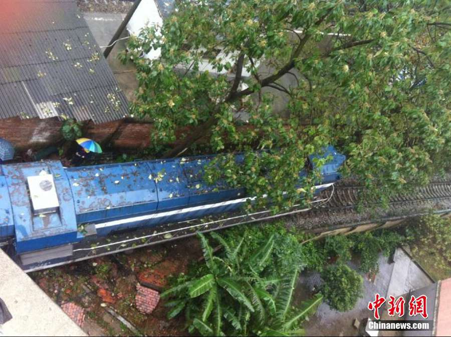 Derailed train crashes into residences in South China