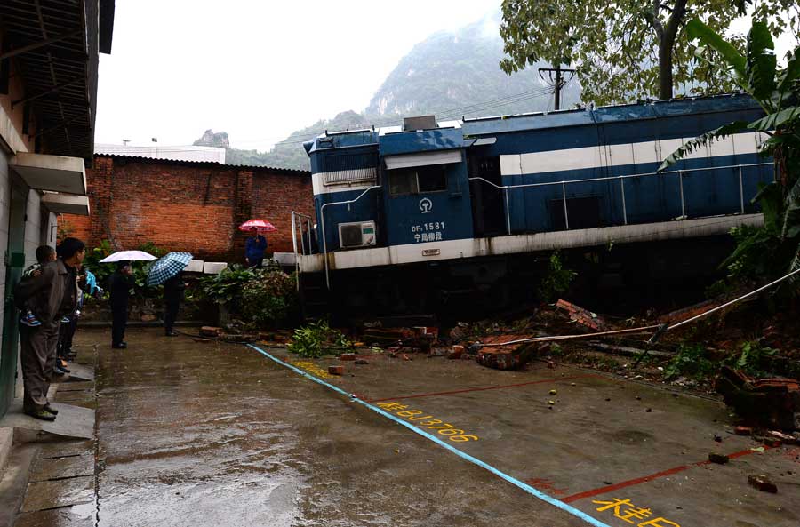 Derailed train crashes into residences in South China