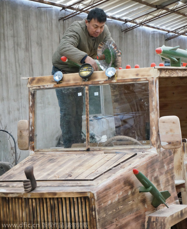 Carpenter carves armored vehicle from wood