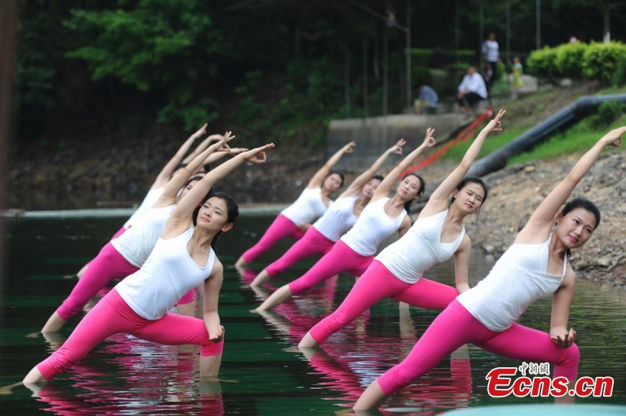 Yoga enthusiasts dance in water