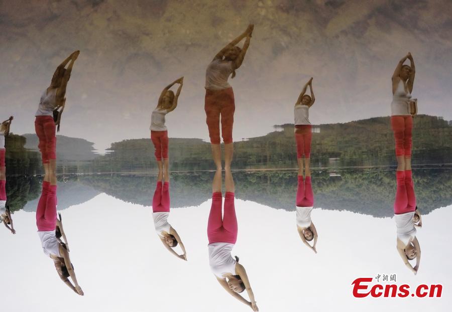 Yoga enthusiasts dance in water