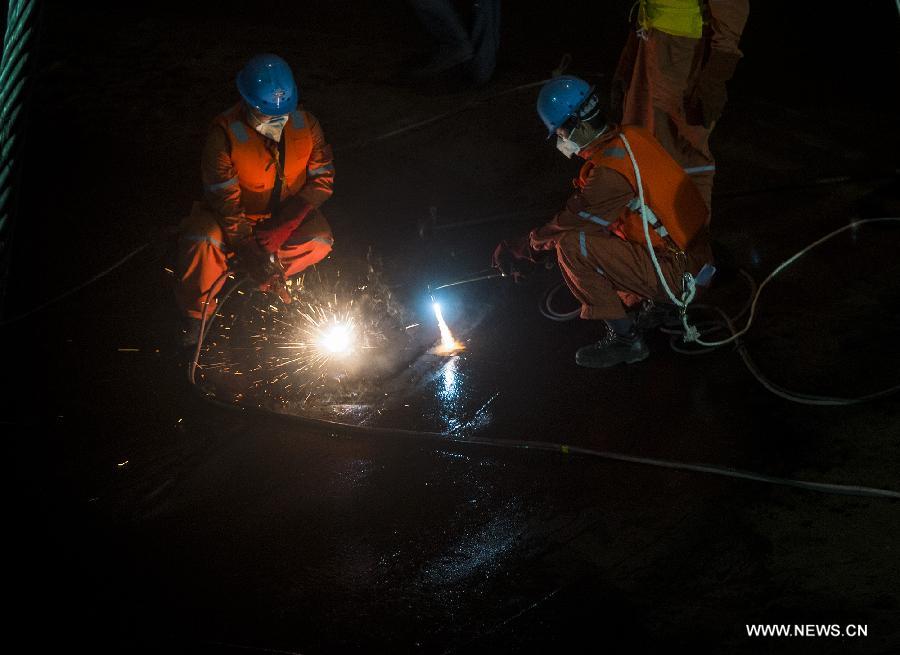 Rescuers cut into capsized ship in search for survivors