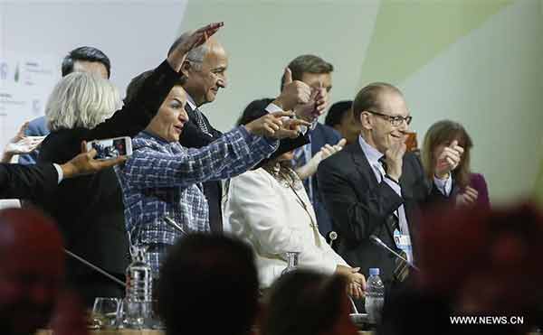 China urges implementation after historic climate deal sealed