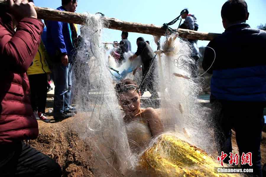 College students dressed in mermaid costumes to call for fishing halt