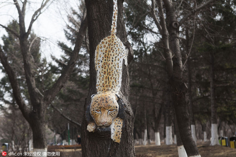 Carved figures emerge from trees in Northeast China