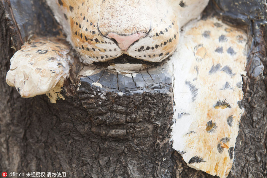 Carved figures emerge from trees in Northeast China