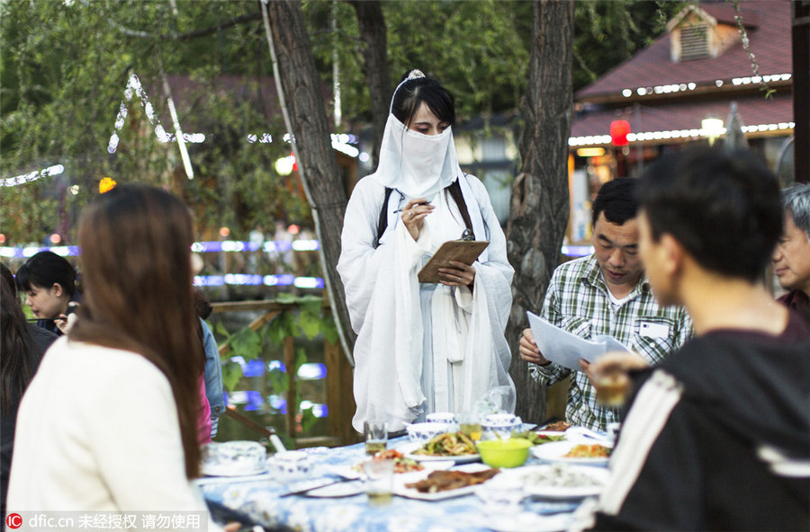 Restaurant employees serve history in traditional costumes