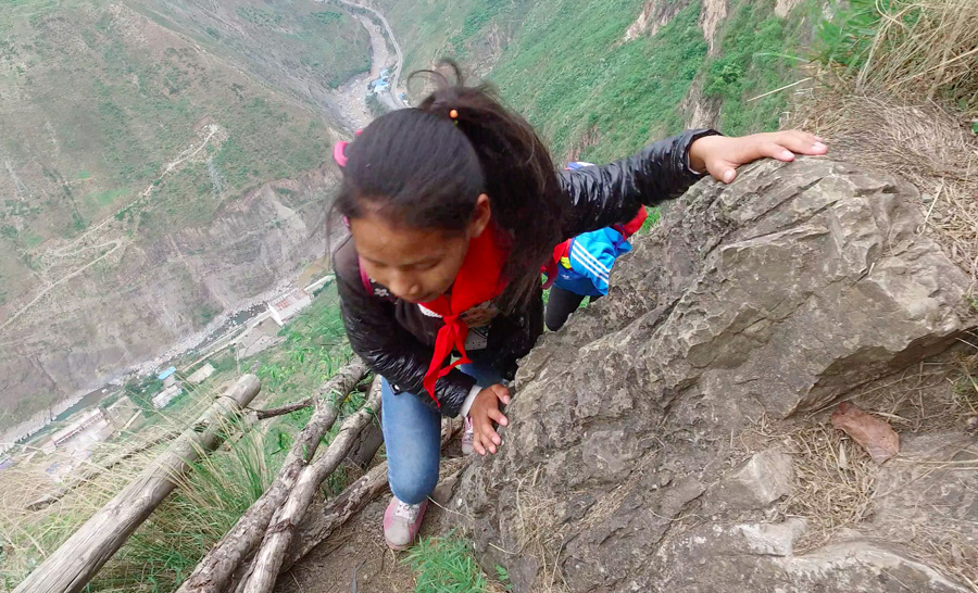 Children scale 800-meter cliff on way to school