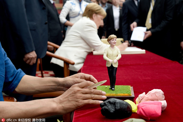 Dough figurine and local cuisine welcome Merkel in Northeast China's Shenyang