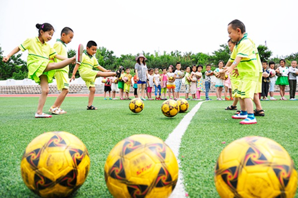 Kicking the ball: Kindergarten children play soccer