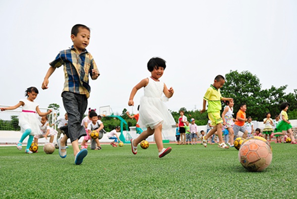 Kicking the ball: Kindergarten children play soccer
