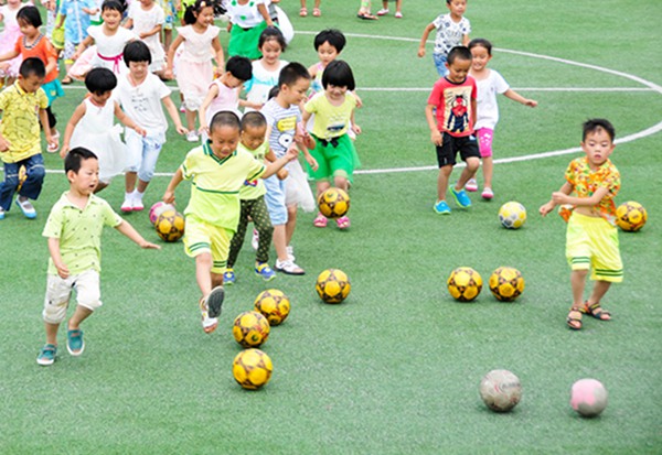 Kicking the ball: Kindergarten children play soccer