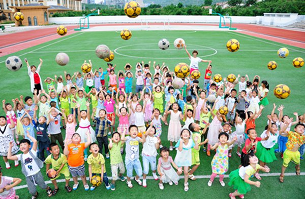 Kicking the ball: Kindergarten children play soccer