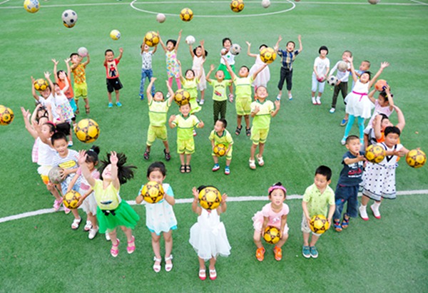 Kicking the ball: Kindergarten children play soccer