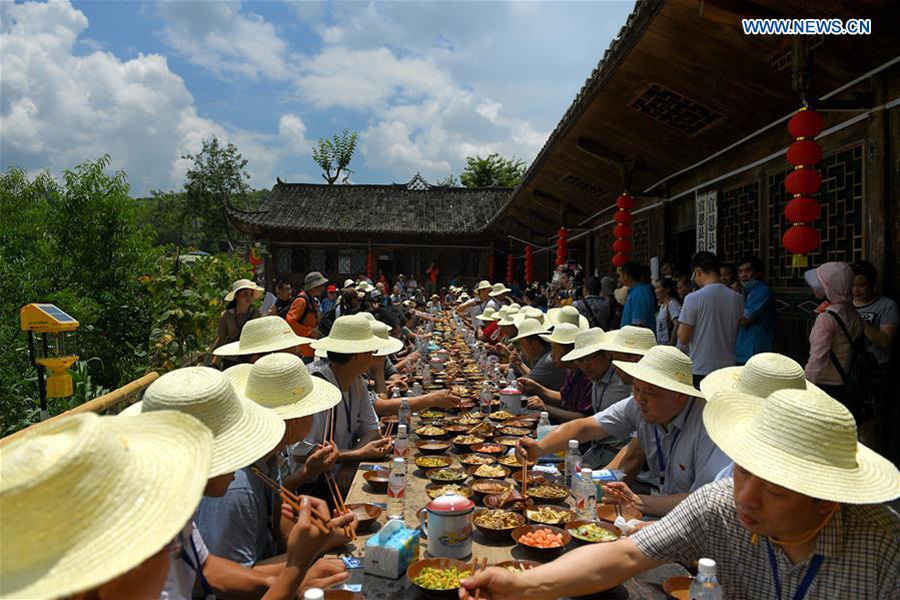 People enjoy meal during 'Helong Banquet' in Central China