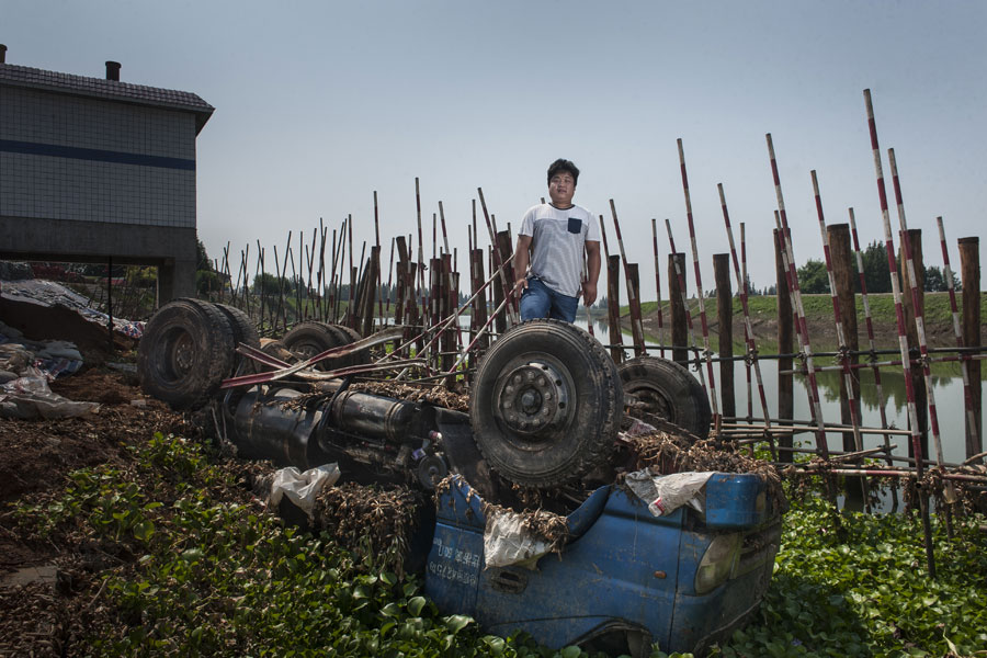 Residents sacrifice their vehicles to stop flood waters