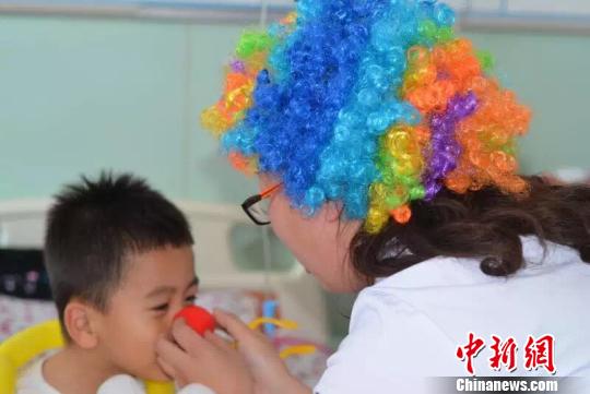 Volunteers dress up as clowns to cheer up hospital patients