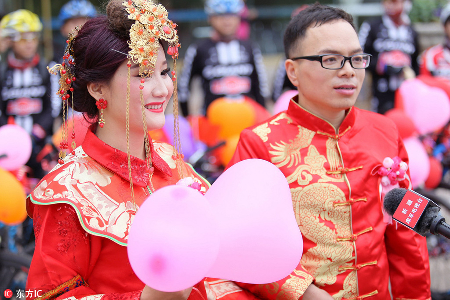 Groom and bride cycle their way to wedding