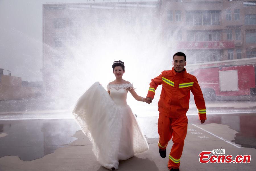 Firefighter poses for unconventional wedding photos