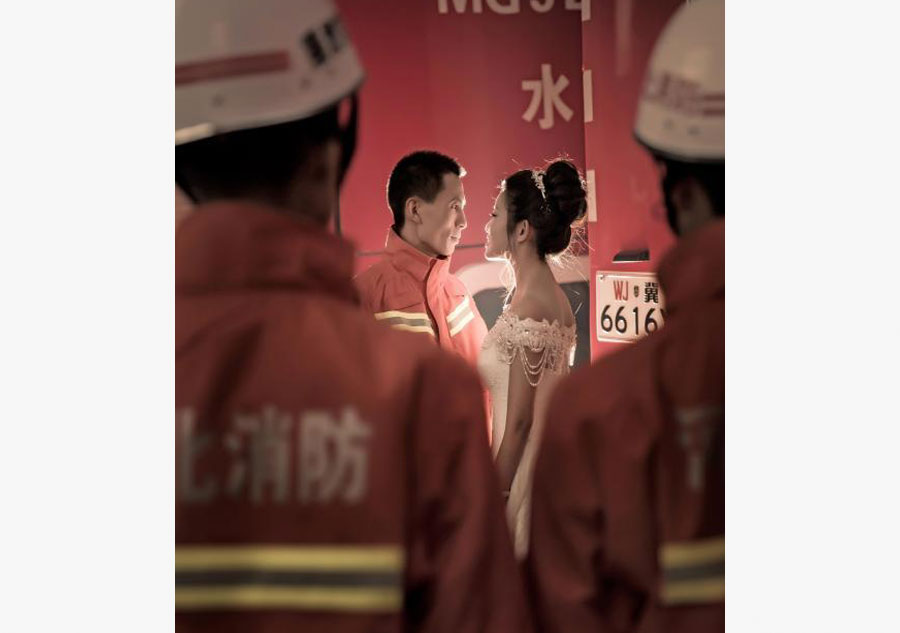 Firefighter poses for unconventional wedding photos