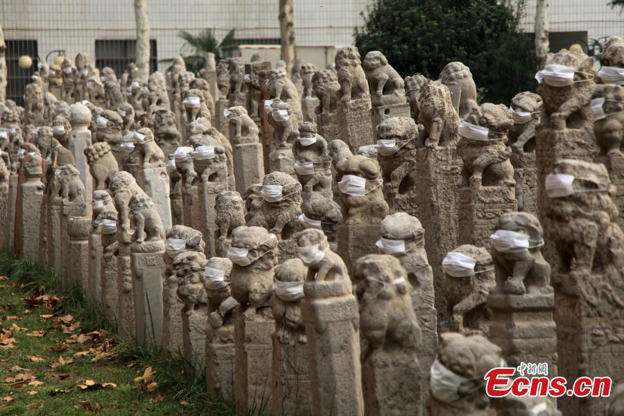 Art students put masks on stone lions in protest of air pollution