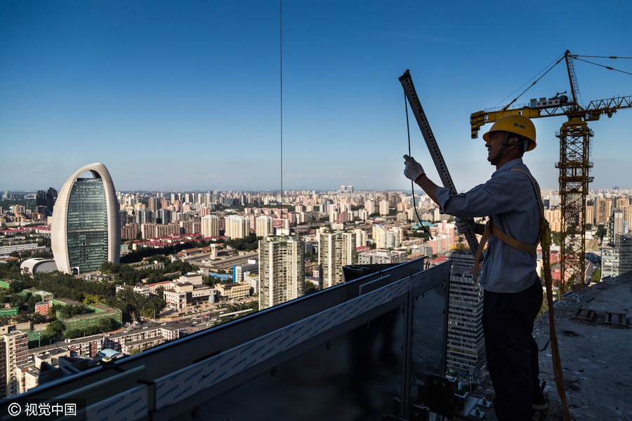 Workers behind Beijing's tallest building