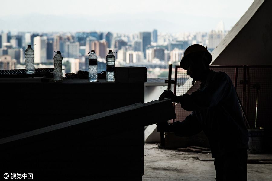 Workers behind Beijing's tallest building