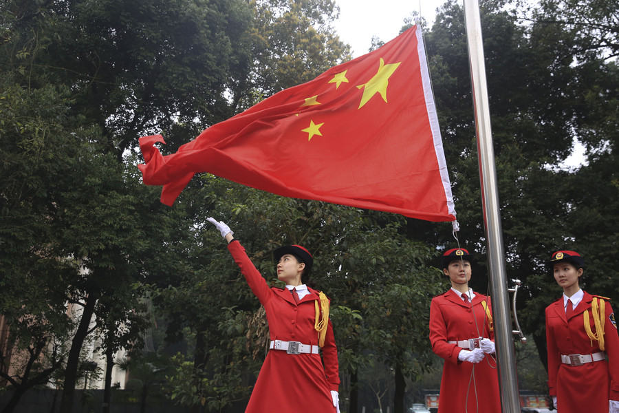 Marching in step: Female college students form flag-raising team