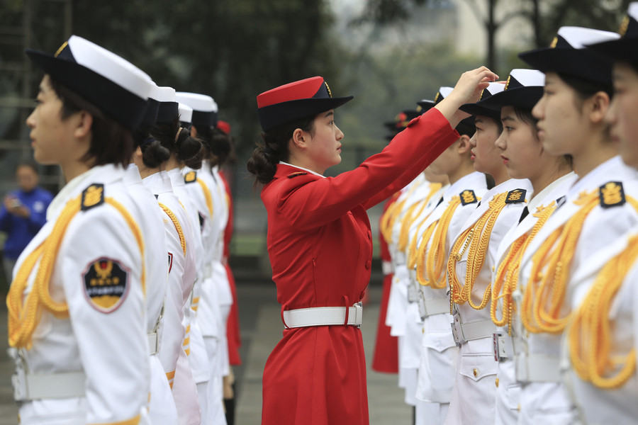 Marching in step: Female college students form flag-raising team