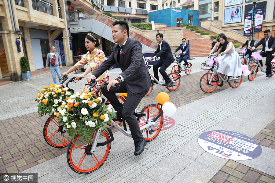 Sharing is caring: Newlyweds take bike-sharing ride