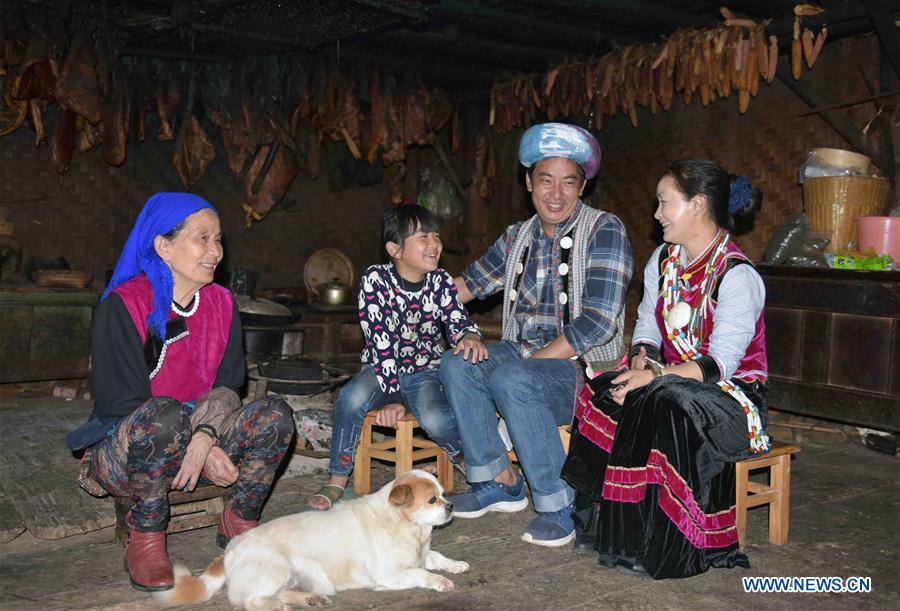 Nu ethnic couple and their family stay in SW China's village