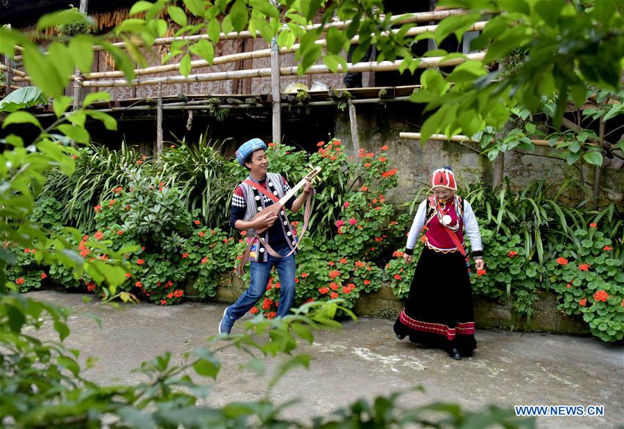 Nu ethnic couple and their family stay in SW China's village